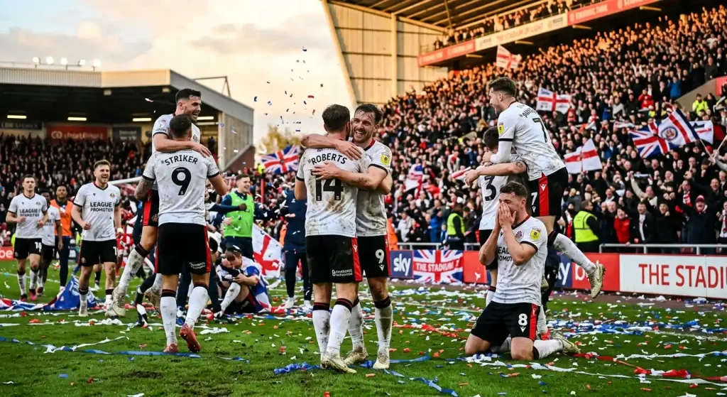 League One players celebrating after clinching a promotion-deciding victory