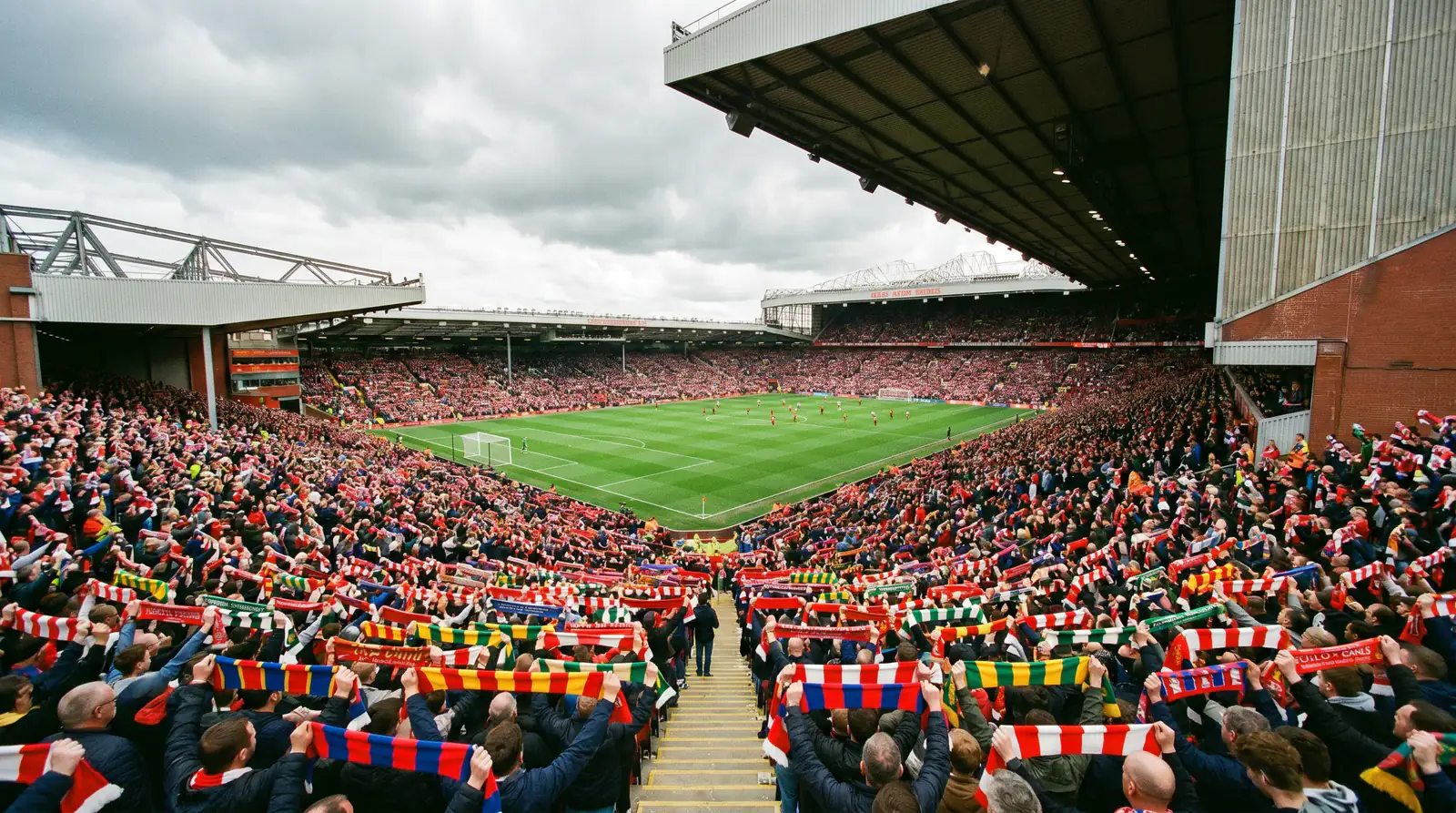 Packed UK football stadium on matchday with fans watching from the stands